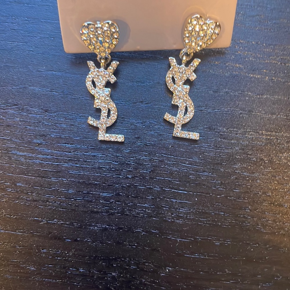 Silver earrings. New. With rhinestones